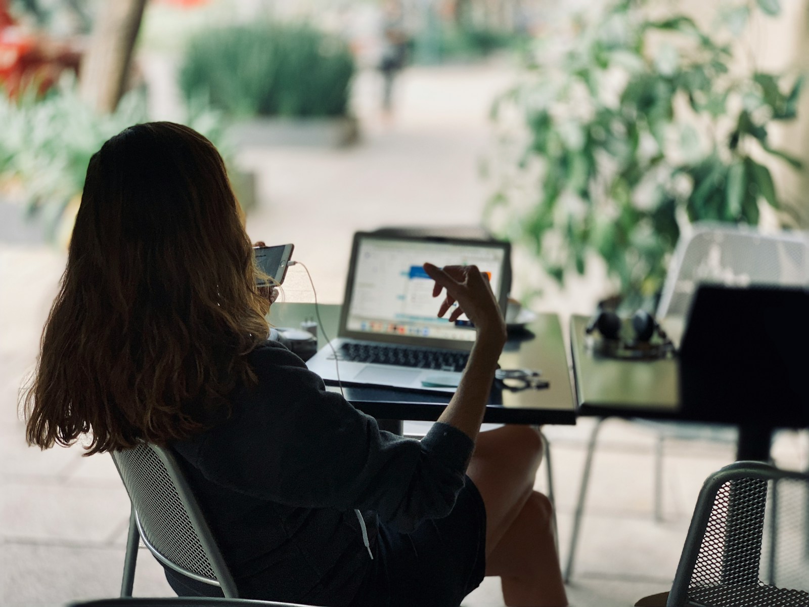 Photo by hj barraza woman sitting on chair in front of table with laptop